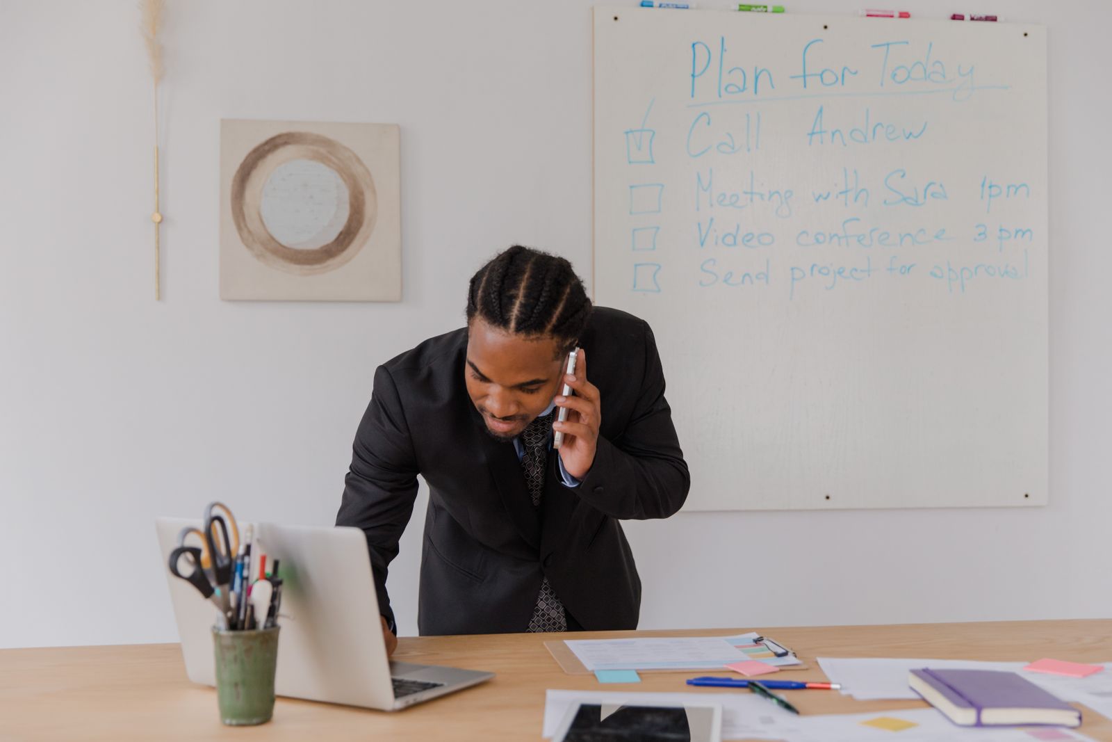 Business operator planning multi-location marketing at a laptop desk
